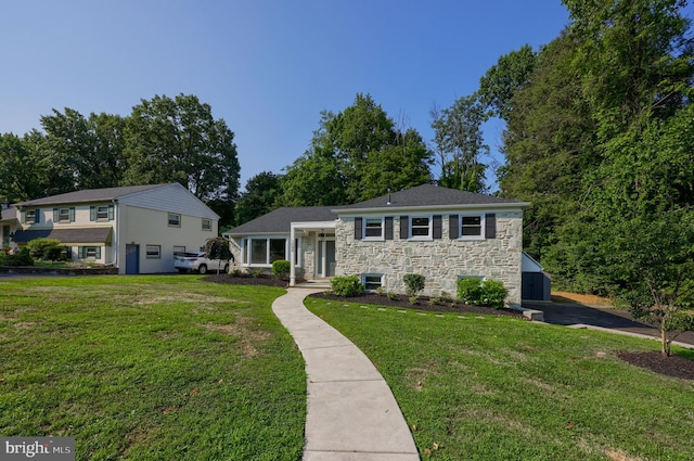 tri-level home featuring a garage and a front lawn