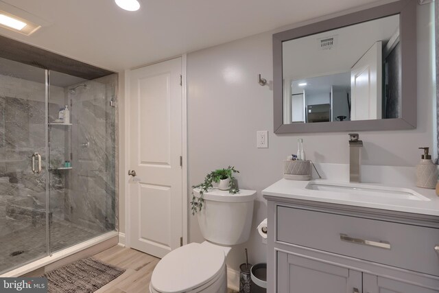 bathroom with vanity, walk in shower, wood-type flooring, and toilet