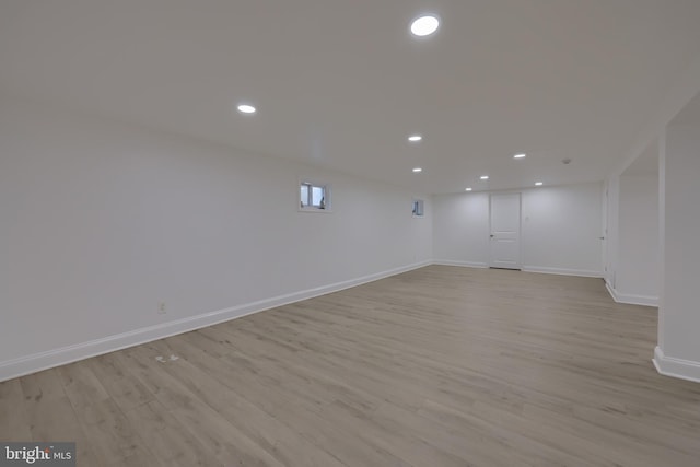 basement with light hardwood / wood-style flooring