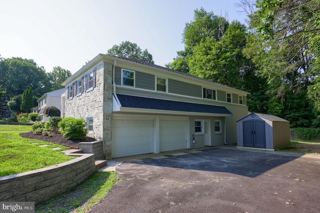 view of front of house with a garage and a shed