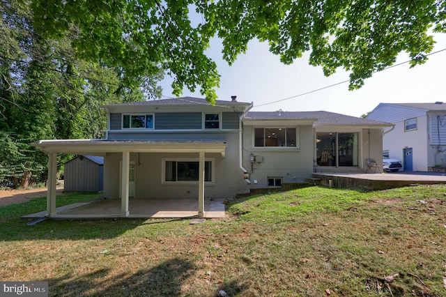 rear view of house with a patio and a yard