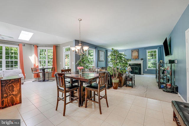 dining space featuring plenty of natural light, light tile patterned floors, and a chandelier