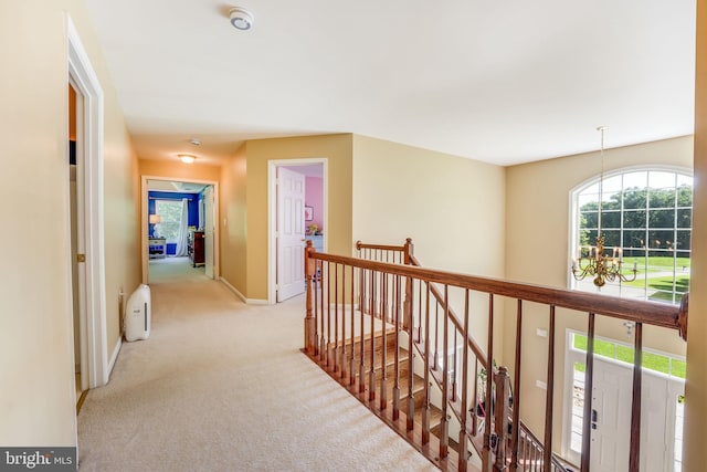 hallway featuring light colored carpet