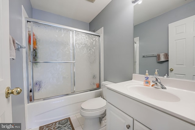 full bathroom with vanity, combined bath / shower with glass door, tile patterned floors, and toilet