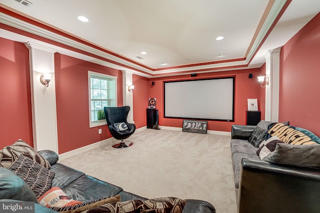 home theater with decorative columns, crown molding, carpet floors, and a tray ceiling