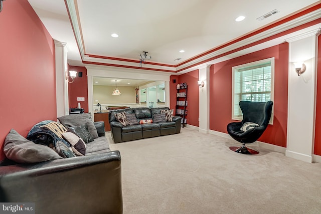 interior space with ornamental molding, carpet flooring, a raised ceiling, and decorative columns