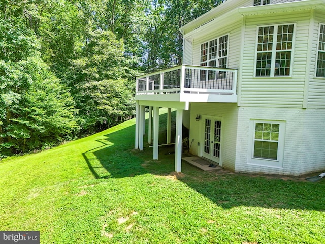 view of yard with french doors and a deck