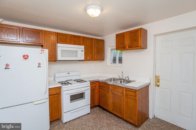 kitchen with sink, white appliances, and light tile patterned floors