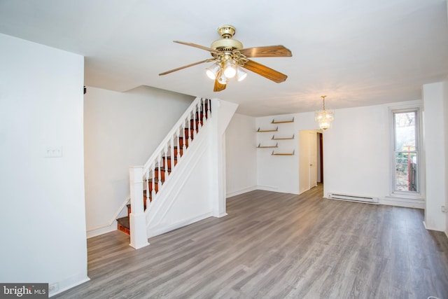 unfurnished living room with a baseboard heating unit, hardwood / wood-style flooring, and ceiling fan with notable chandelier