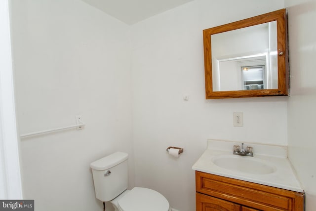 bathroom with toilet and vanity