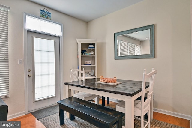 dining area with a healthy amount of sunlight, baseboards, and wood finished floors