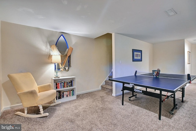 recreation room with carpet, visible vents, and baseboards