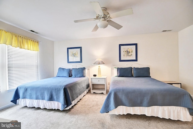 bedroom with a ceiling fan, visible vents, and carpet flooring