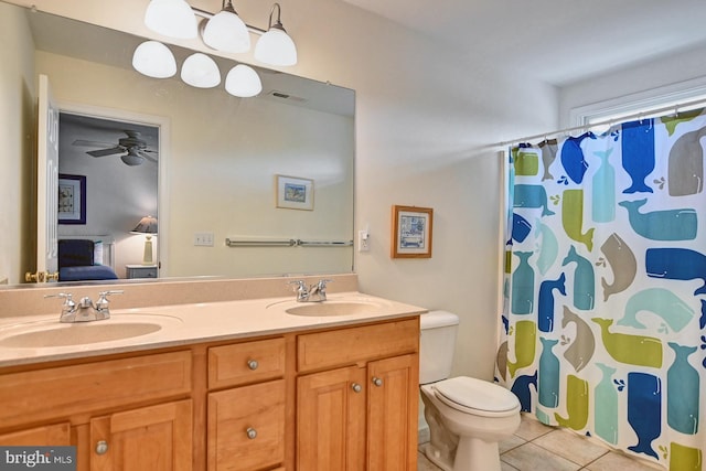 full bathroom featuring double vanity, a sink, visible vents, and tile patterned floors