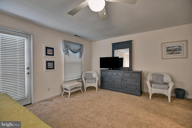 sitting room with light colored carpet, ceiling fan, visible vents, and baseboards