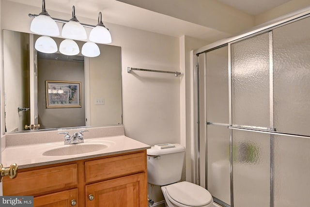 full bath featuring toilet, a shower stall, and vanity