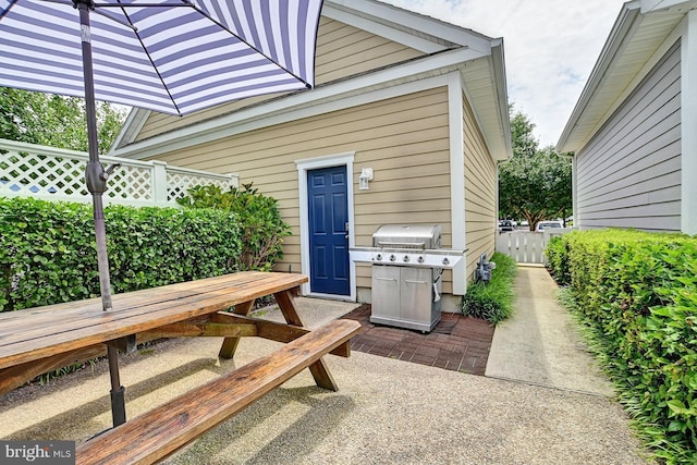 view of patio / terrace featuring a grill and fence