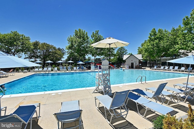 pool featuring fence and a patio