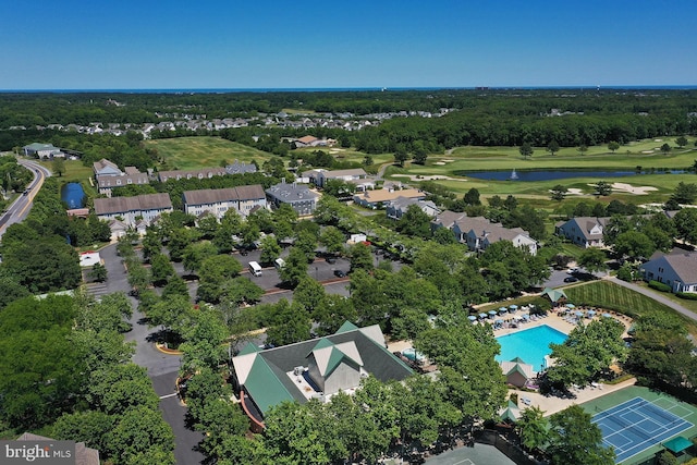 drone / aerial view with a water view and golf course view