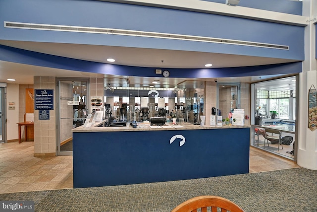 bar with tile patterned flooring and recessed lighting