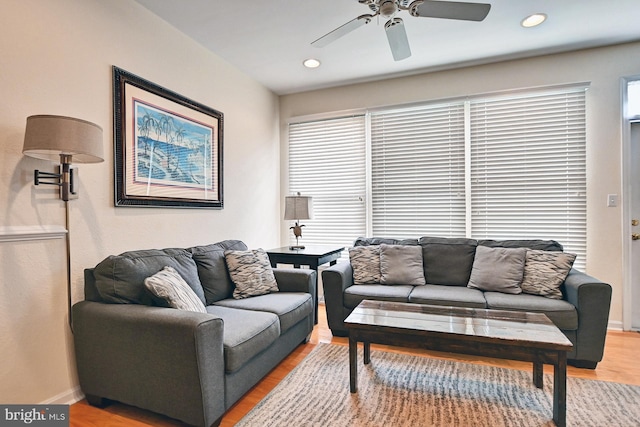 living room featuring baseboards, ceiling fan, recessed lighting, and light wood-style floors