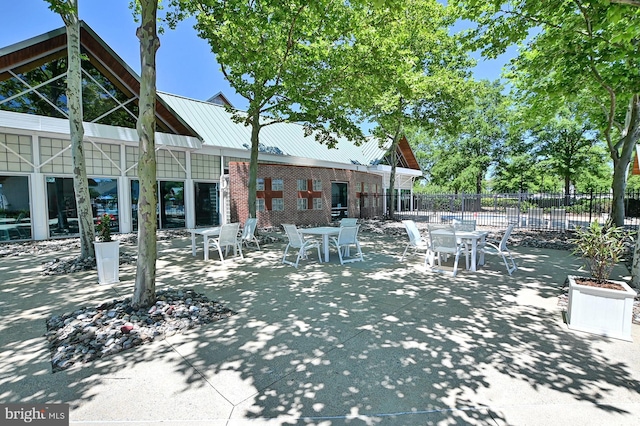 view of patio with outdoor dining area and fence