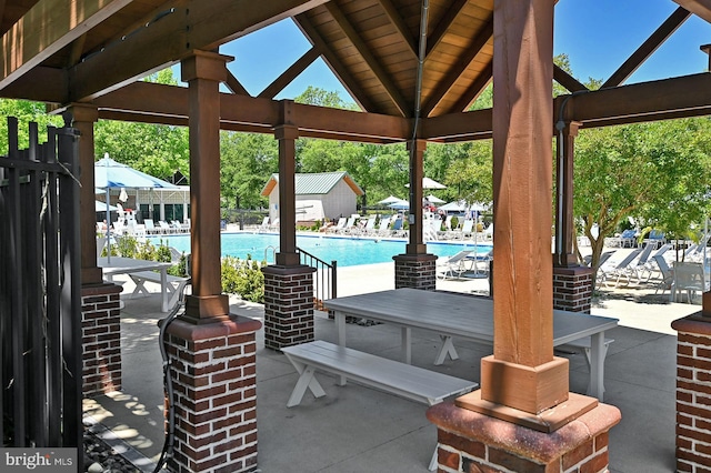 view of patio / terrace with a gazebo and a community pool