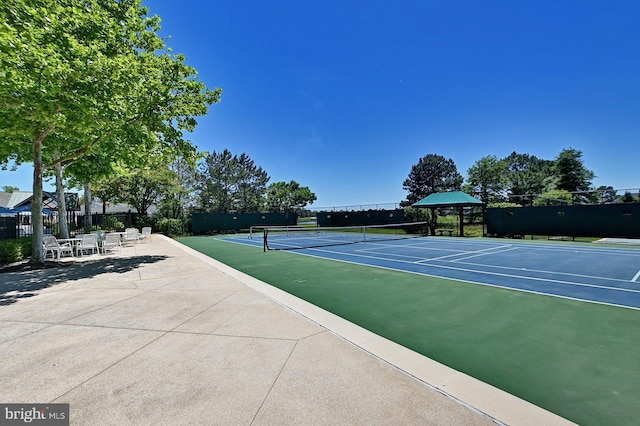 view of sport court featuring fence