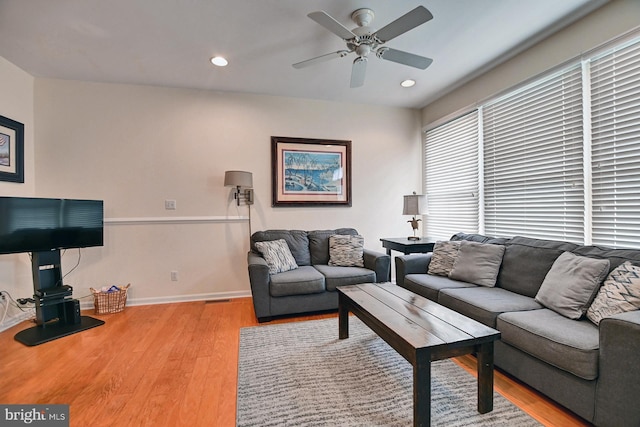 living room with baseboards, wood finished floors, a ceiling fan, and recessed lighting