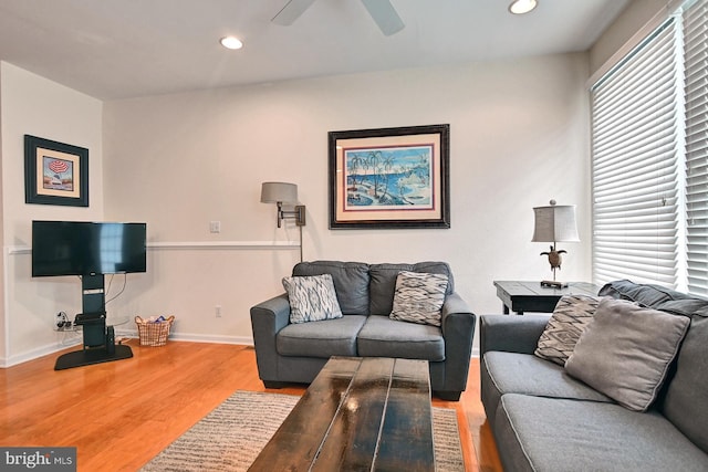 living area with a healthy amount of sunlight, baseboards, wood finished floors, and recessed lighting