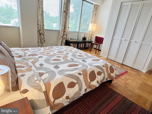 bedroom featuring multiple windows and a closet