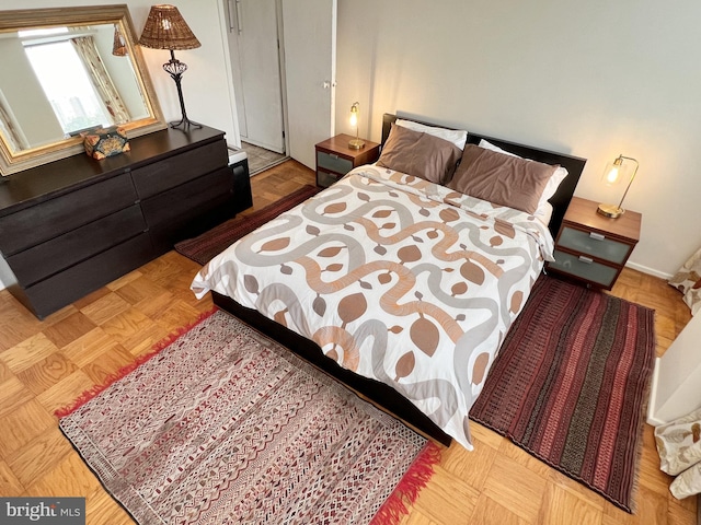 bedroom featuring light parquet flooring