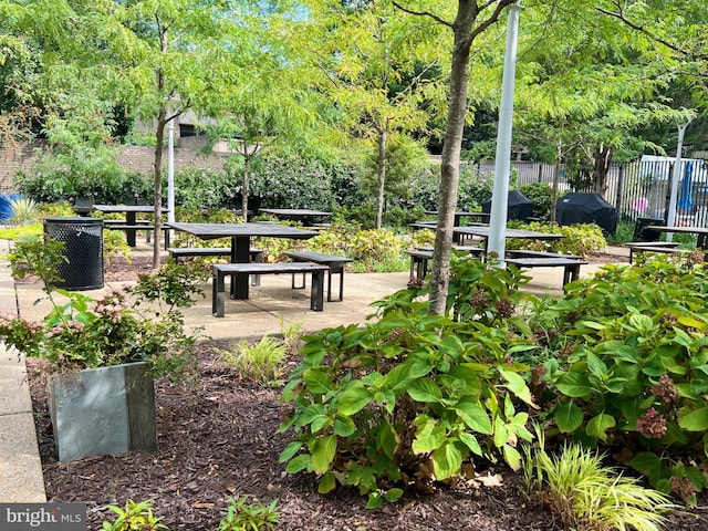 view of community with a patio and fence