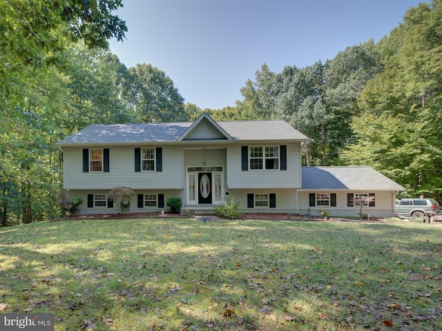 split foyer home with a front lawn