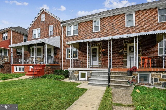 multi unit property with a porch, cooling unit, and a front yard