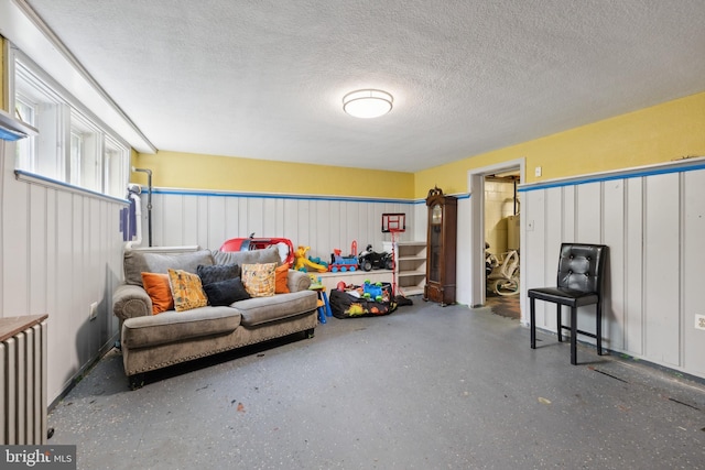 interior space with radiator heating unit and a textured ceiling