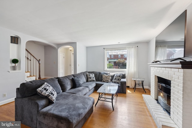 living room with a fireplace and light hardwood / wood-style flooring