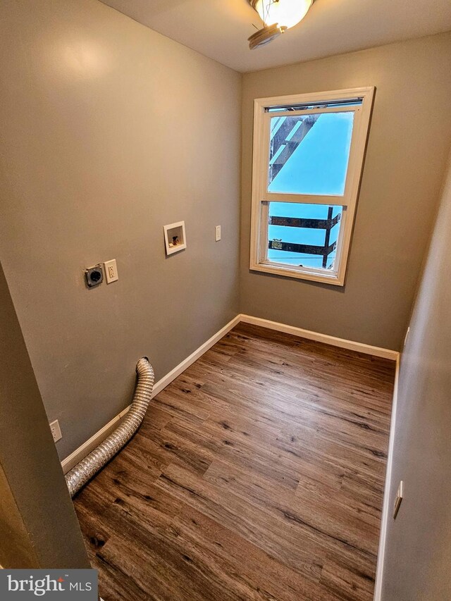 washroom featuring electric dryer hookup, hookup for a washing machine, and hardwood / wood-style floors