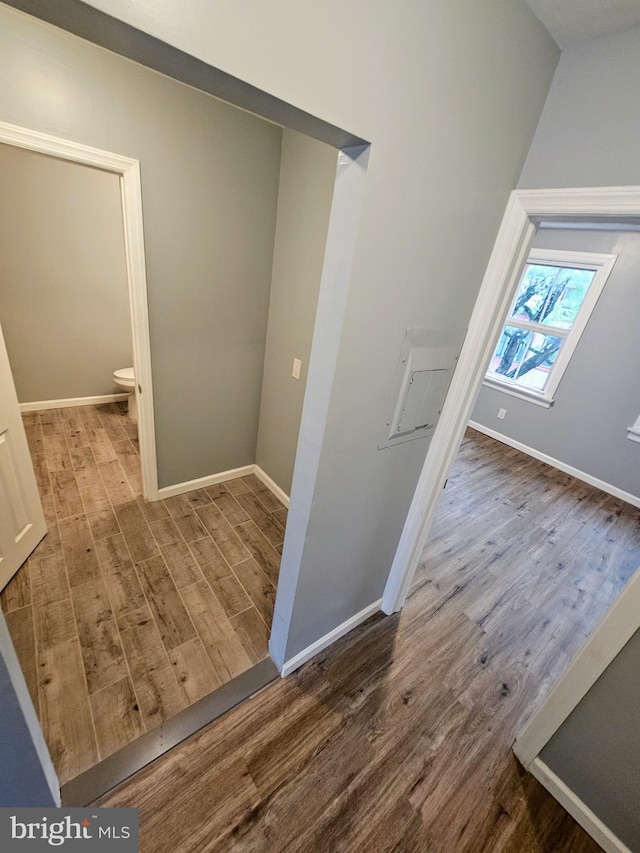 corridor with wood-type flooring