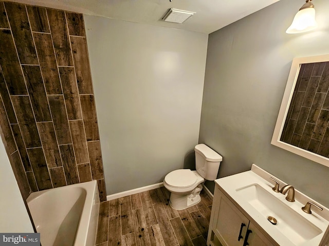 bathroom with vanity, toilet, and wood-type flooring