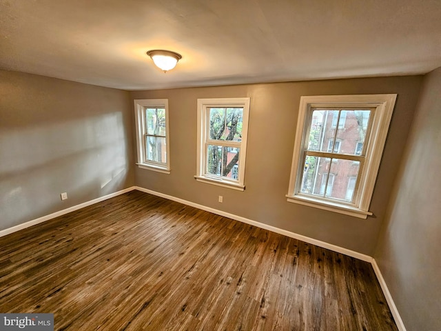 unfurnished room featuring dark hardwood / wood-style flooring