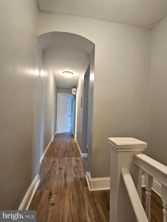 corridor with hardwood / wood-style floors