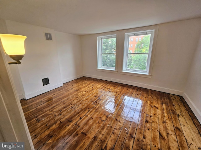 empty room with hardwood / wood-style floors