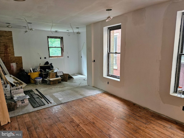 unfurnished living room with plenty of natural light and hardwood / wood-style floors