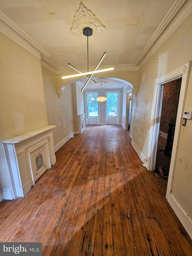 corridor with wood-type flooring and ornamental molding