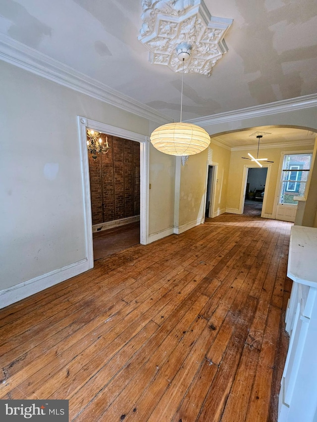 unfurnished dining area featuring crown molding and hardwood / wood-style floors