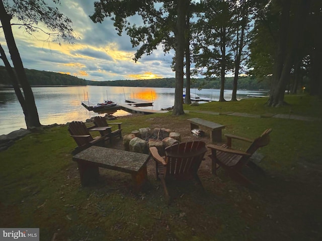 view of patio / terrace featuring a dock and a water view