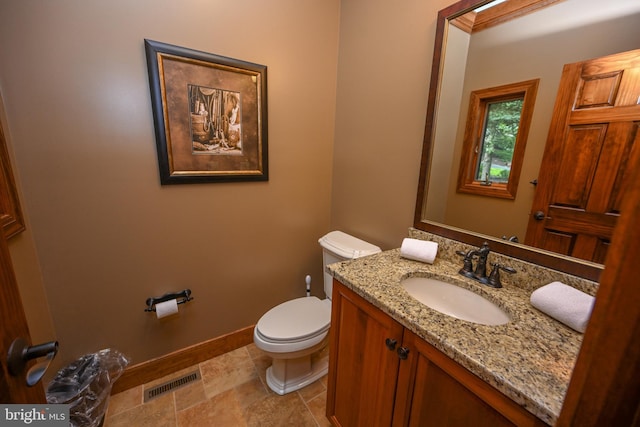 bathroom featuring tile patterned floors, vanity, and toilet