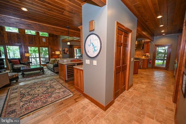 hallway with wine cooler, wooden ceiling, a wealth of natural light, and baseboards