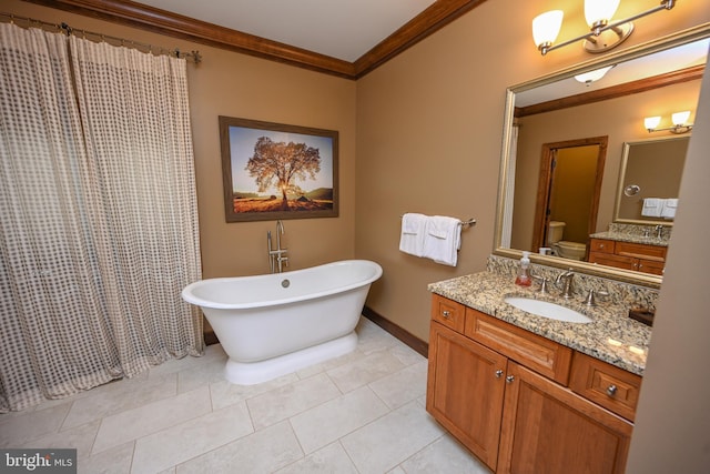 full bathroom featuring crown molding, toilet, vanity, tile patterned flooring, and a freestanding tub